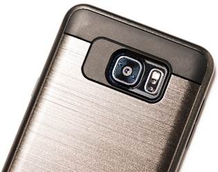 Close up of the camera lens on the back of a cell phone.