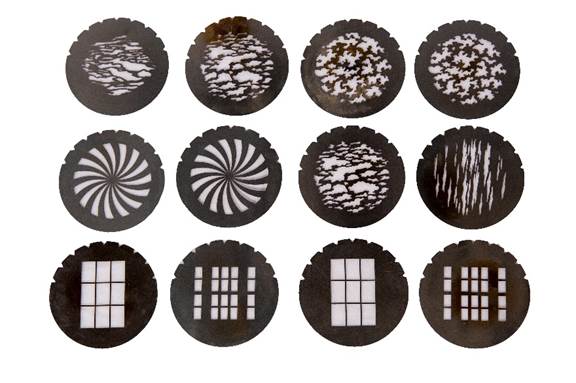 Assortment of discs with varying textures and patterns in the center. Used to cast shadows of the design.